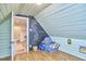 Attic play space featuring chalkboard wall, seating, and access door to kitchen at 1516 Edgevale Rd, Durham, NC 27701