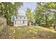 View of the expansive backyard of the home featuring mature trees and a full privacy fence at 1516 Edgevale Rd, Durham, NC 27701