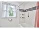 Updated bathroom with white subway tiles, and a shower-tub combination at 1516 Edgevale Rd, Durham, NC 27701