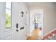 Bright entryway features hardwood floors, white trim, and access to other rooms at 1516 Edgevale Rd, Durham, NC 27701