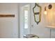Hallway with a mirror, light fixture, and transom window above a door at 1516 Edgevale Rd, Durham, NC 27701