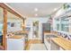 Bright kitchen features stainless steel appliances, farmhouse sink, and wooden countertops at 1516 Edgevale Rd, Durham, NC 27701