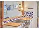 Kitchen area with wooden countertops, blue patterned tiling and stainless steel stove at 1516 Edgevale Rd, Durham, NC 27701