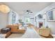 Cozy living room featuring a decorative fireplace, ceiling fan, and comfortable seating area at 1516 Edgevale Rd, Durham, NC 27701