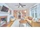Comfortable living room with fireplace, built-in shelving, couch, and natural light at 1516 Edgevale Rd, Durham, NC 27701