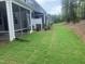View of backyard featuring grassy areas, trees, and newly installed landscaping at 1524 Chirping Bird Ct, Cary, NC 27519