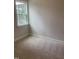 A bright bedroom featuring neutral carpeting, a window, and fresh paint at 1524 Chirping Bird Ct, Cary, NC 27519