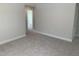 Comfortable bedroom with neutral carpeting and a view into the hallway at 1524 Chirping Bird Ct, Cary, NC 27519
