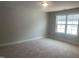 Bright and spacious bedroom featuring a window, soft carpet, and neutral paint at 1524 Chirping Bird Ct, Cary, NC 27519