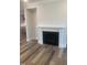 Living room fireplace with white mantel and cabinets on both sides, and grey walls and wood-look flooring at 1524 Chirping Bird Ct, Cary, NC 27519