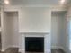 Living room fireplace with white mantel and cabinets on both sides, and grey walls at 1524 Chirping Bird Ct, Cary, NC 27519