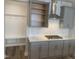 Kitchen features gray cabinets, stainless steel vent hood, gas cooktop, white subway tile backsplash, and a hall tree at 1524 Chirping Bird Ct, Cary, NC 27519