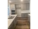 Modern kitchen featuring stainless steel appliances, gray cabinets, quartz countertops, and a stylish faucet at 1524 Chirping Bird Ct, Cary, NC 27519