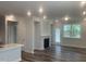 Bright living room with a fireplace, hardwood floors, recessed lighting, and a doorway to the backyard at 1524 Chirping Bird Ct, Cary, NC 27519