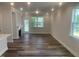 Bright and airy living room with fireplace, hardwood floors, large windows, and modern fixtures at 1524 Chirping Bird Ct, Cary, NC 27519