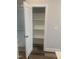 A well-organized pantry with white shelves and ample storage space, complemented by stylish flooring at 1524 Chirping Bird Ct, Cary, NC 27519