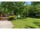 A beautiful backyard features a deck, storage shed and mature trees at 1601 Redmond Dr, Durham, NC 27712