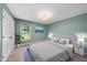 This bedroom offers natural light, light paint, a large bed and ample space at 1601 Redmond Dr, Durham, NC 27712