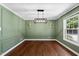 Spacious dining room with stylish light fixtures, natural light, and beautiful hardwood flooring at 1601 Redmond Dr, Durham, NC 27712