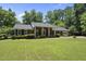Charming brick home featuring a covered front porch and well-manicured lawn at 1601 Redmond Dr, Durham, NC 27712