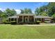 Beautiful brick home with a lush green lawn, classic black shutters, and a covered front entry at 1601 Redmond Dr, Durham, NC 27712