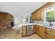 Open kitchen with modern appliances, adjacent fireplace, and easy access to other rooms at 1601 Redmond Dr, Durham, NC 27712