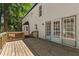 Wood deck leads to the white home featuring French doors, perfect for outdoor entertaining at 1609 Falls Ct, Raleigh, NC 27615