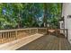 Expansive wooden deck is perfect for entertaining or enjoying the serene backyard views at 1609 Falls Ct, Raleigh, NC 27615