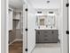 Modern bathroom featuring double vanity sinks, with a walk-in closet to the left at 1609 Falls Ct, Raleigh, NC 27615