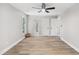 Bedroom featuring hardwood floors, natural light, and two doors at 1609 Falls Ct, Raleigh, NC 27615