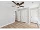 Neutral bedroom with a ceiling fan, hardwood floors, and white doors and trim at 1609 Falls Ct, Raleigh, NC 27615