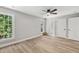 Bedroom featuring hardwood floors, natural light, and a view to Primary bathroom at 1609 Falls Ct, Raleigh, NC 27615