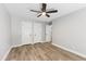 Neutral bedroom with a ceiling fan, hardwood floors, and white doors and trim at 1609 Falls Ct, Raleigh, NC 27615