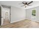 Bedroom featuring hardwood floors, view to hall, and a window for natural light at 1609 Falls Ct, Raleigh, NC 27615
