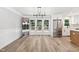 Bright dining room features french doors to deck, neutral paint and stainless steel refrigerator at 1609 Falls Ct, Raleigh, NC 27615