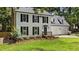 Charming two-story home with brick chimney, white siding, and a well-manicured lawn at 1609 Falls Ct, Raleigh, NC 27615