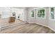 Open concept kitchen and dining area with hardwood floors and large windows for natural light at 1609 Falls Ct, Raleigh, NC 27615