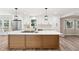 Beautiful kitchen boasts white cabinets, stainless steel appliances, and an island with a white countertop at 1609 Falls Ct, Raleigh, NC 27615
