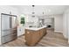 Beautiful kitchen boasts white cabinets, stainless steel appliances, and an island with a white countertop at 1609 Falls Ct, Raleigh, NC 27615
