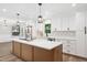 Beautiful kitchen boasts white cabinets, stainless steel appliances, and an island with a white countertop at 1609 Falls Ct, Raleigh, NC 27615