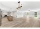 Spacious living room features a brick fireplace, modern lighting and an open floorplan at 1609 Falls Ct, Raleigh, NC 27615