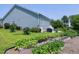 Large backyard with garden beds and lush green lawn extending to the exterior of the home at 1918 Morning Fog Dr, Fuquay Varina, NC 27526
