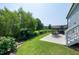 Expansive backyard featuring a well-manicured lawn, garden beds, a patio, and mature trees at 1918 Morning Fog Dr, Fuquay Varina, NC 27526