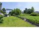 Lush backyard featuring garden beds, a well-kept lawn, and a view of the back of the house with a patio at 1918 Morning Fog Dr, Fuquay Varina, NC 27526