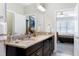 Bathroom featuring granite countertop, vanity, mirror, and an open doorway to a bedroom at 1918 Morning Fog Dr, Fuquay Varina, NC 27526