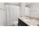Bathroom with granite vanity, toilet, decorative shower curtain, and well-lit mirror at 1918 Morning Fog Dr, Fuquay Varina, NC 27526