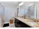 Modern bathroom with double sinks, granite countertops, a framed mirror, and a tiled shower at 1918 Morning Fog Dr, Fuquay Varina, NC 27526