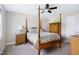 Bedroom with a four-poster bed, bedside tables, lamp, and a serene, inviting ambiance at 1918 Morning Fog Dr, Fuquay Varina, NC 27526