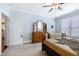 Spacious bedroom with a large bed, comfortable carpet, and access to other parts of the house at 1918 Morning Fog Dr, Fuquay Varina, NC 27526