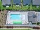 Aerial view of a sparkling community pool with lounge chairs and umbrellas at 1918 Morning Fog Dr, Fuquay Varina, NC 27526